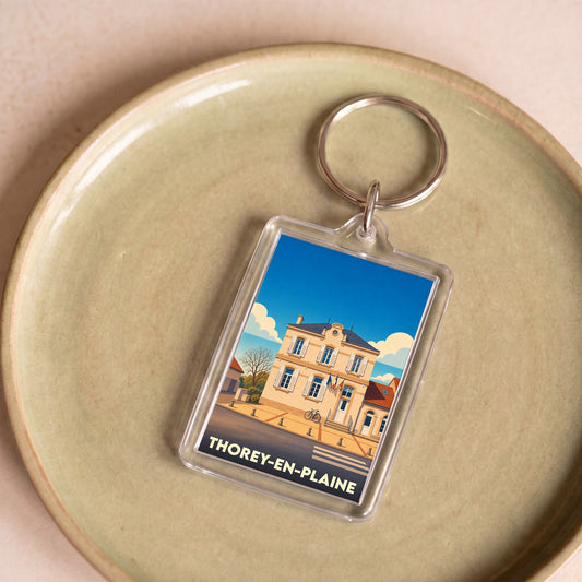 Porte-clés souvenir de la ville de Thorey-en-Plaine avec une illustration stylisée.
