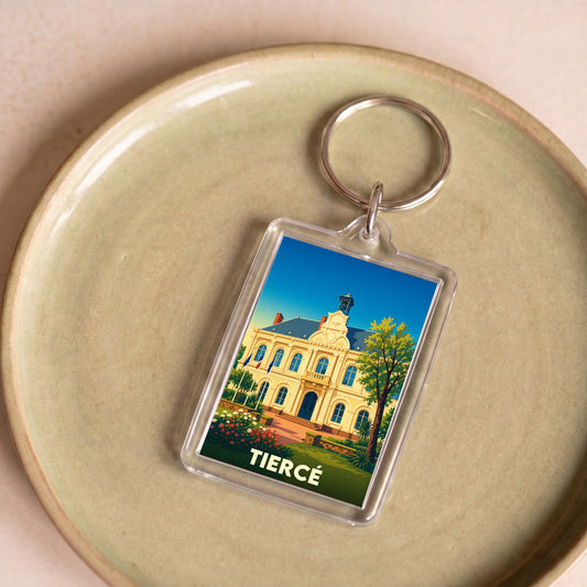 Porte-clés souvenir de la ville de Tiercé avec une illustration stylisée de son hôtel de ville.