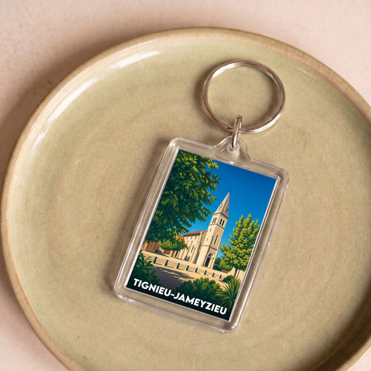Porte-clés souvenir de la ville de Tignieu-Jameyzieu avec une illustration stylisée.