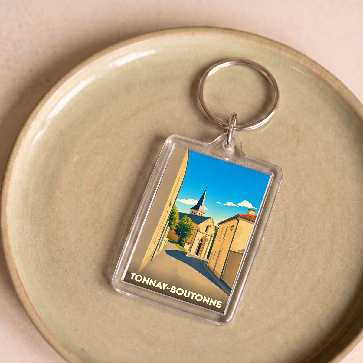 Porte-clés souvenir de la ville de Tonnay-Boutonne avec une illustration stylisée.