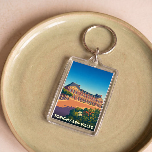 Porte-clés souvenir de la ville de Torigny-les-Villes avec une illustration stylisée de son château.