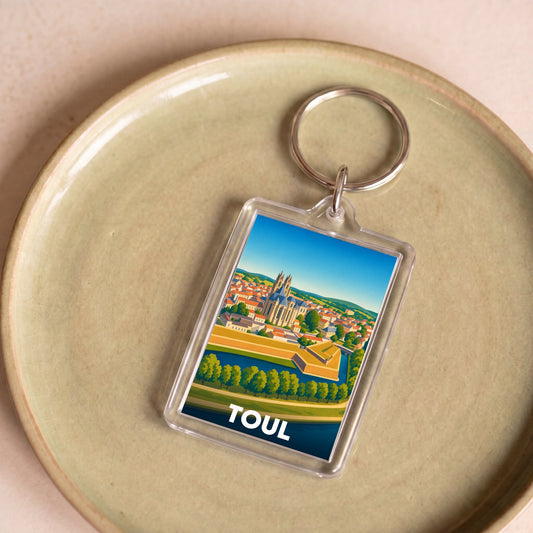Porte-clés souvenir de la ville de Toul avec une illustration stylisée.
