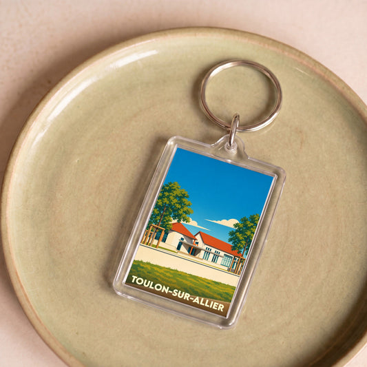 Porte-clés souvenir de la ville de Toulon-sur-Allier avec une illustration stylisée.