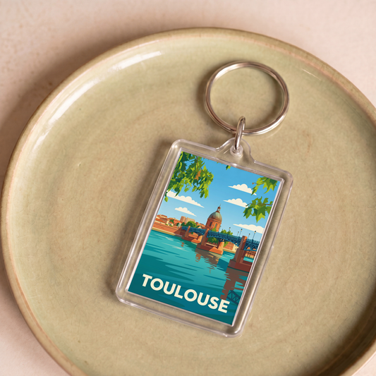 Porte-clés souvenir de la ville de Toulouse avec une illustration stylisée.