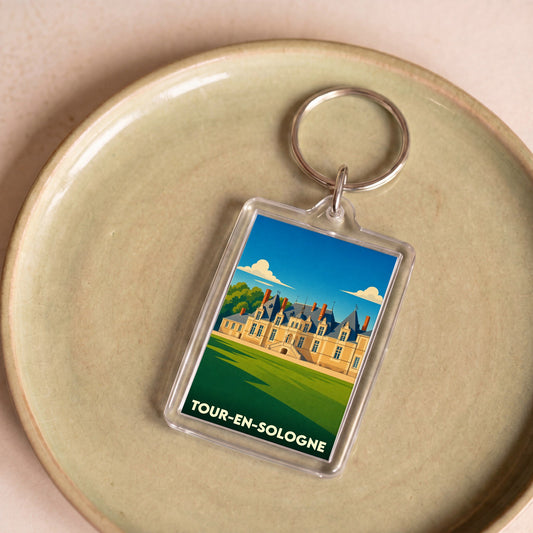 Porte-clés souvenir de la ville de Tour-en-Sologne avec une illustration stylisée du château de Villesavin.