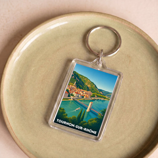 Porte-clés souvenir de la ville de Tournon-sur-Rhône avec une illustration stylisée.