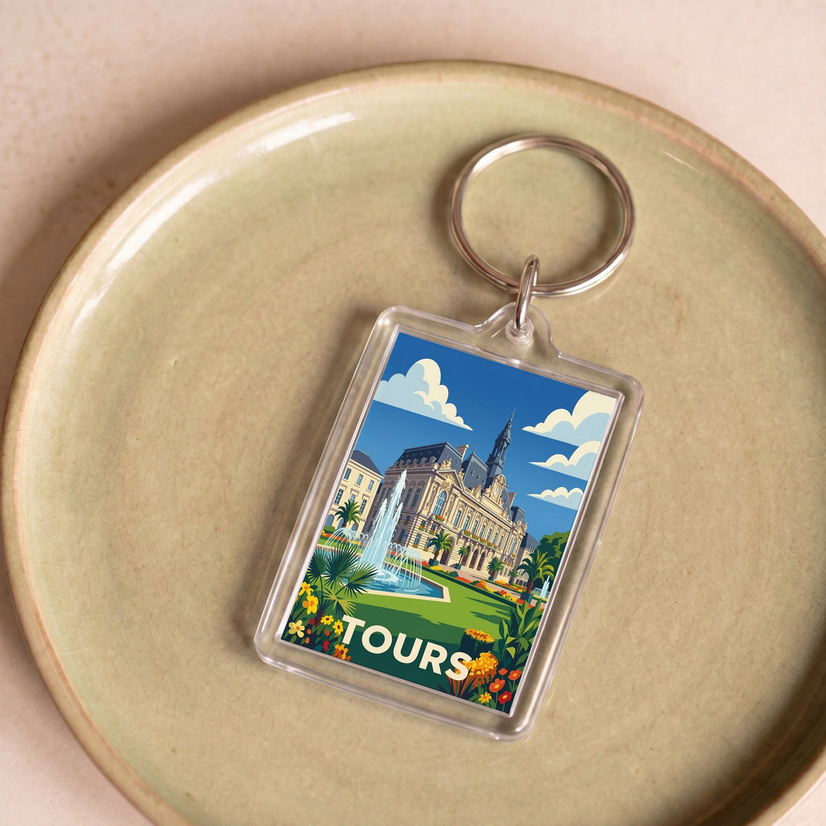 Porte-clés souvenir de la ville de Tours avec une illustration stylisée.