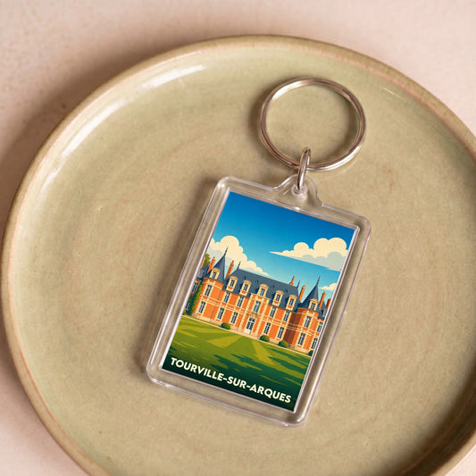 Porte-clés souvenir de la ville de Tourville-sur-Arques avec une illustration stylisée d'un château.