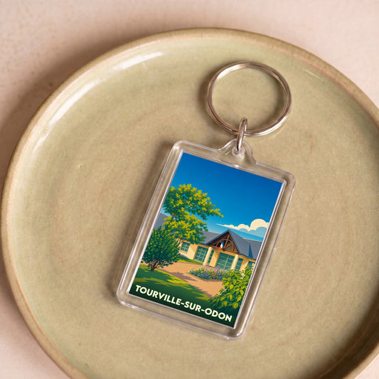 Porte-clés souvenir de la ville de Tourville-sur-Odon avec une illustration stylisée.