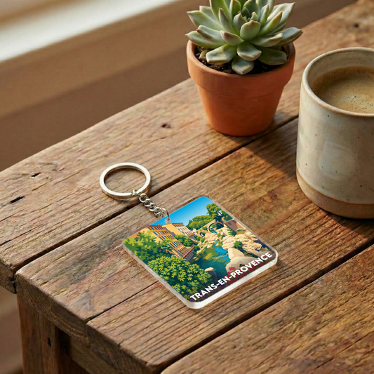 Porte-clés souvenir de la ville de Trans-en-Provence avec une illustration colorée et stylisée.