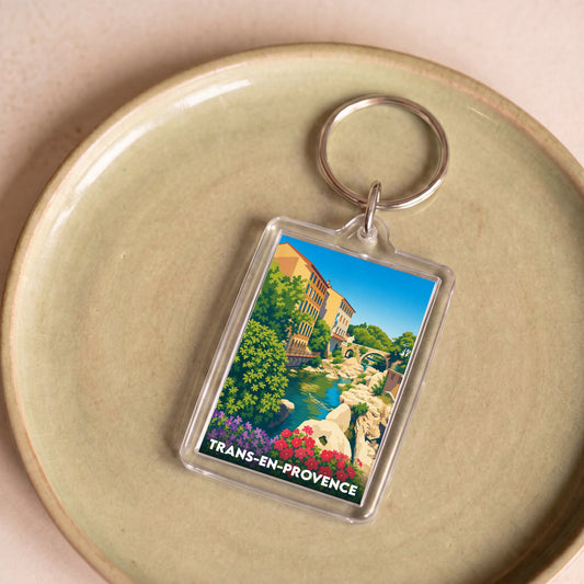 Porte-clés souvenir de la ville de Trans-en-Provence avec une illustration colorée et stylisée.