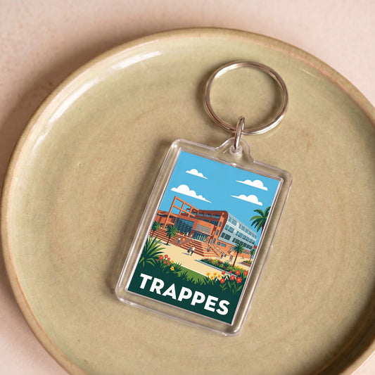 Porte-clés souvenir de la ville de Trappes avec une illustration stylisée et colorée.