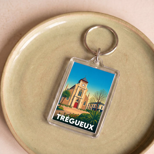 Porte-clés souvenir de la ville de Trégueux avec une illustration stylisée d'un monument local.