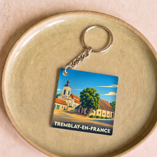 Porte-clés souvenir de la ville de Tremblay-en-France avec une illustration stylisée.