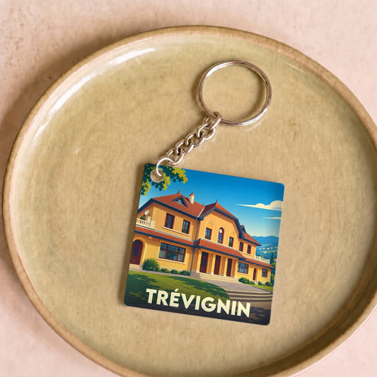 Porte-clés souvenir de la ville de Trévignin avec une illustration stylisée d'un bâtiment emblématique.