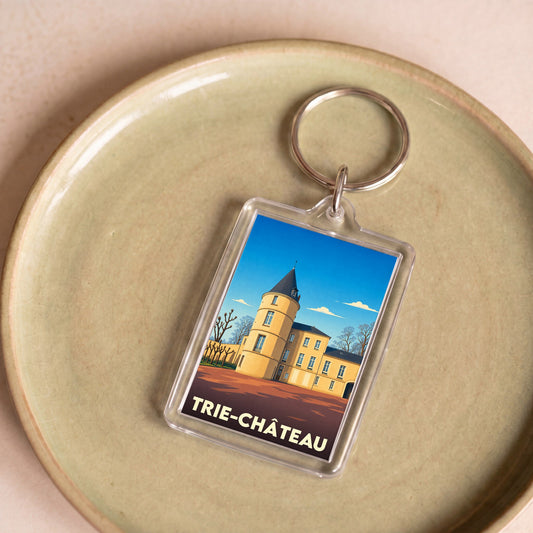 Porte-clés souvenir de la ville de Trie-Château avec une illustration stylisée.