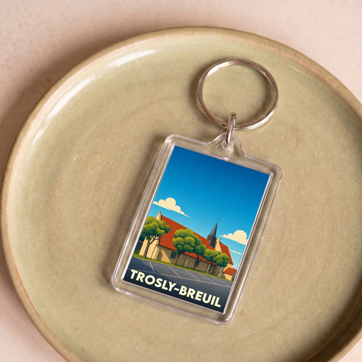 Porte-clés souvenir de la ville de Trosly-Breuil avec une illustration stylisée.