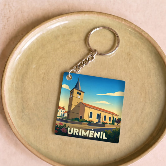 Porte-clés souvenir de la ville de Uriménil avec une illustration stylisée de son église.