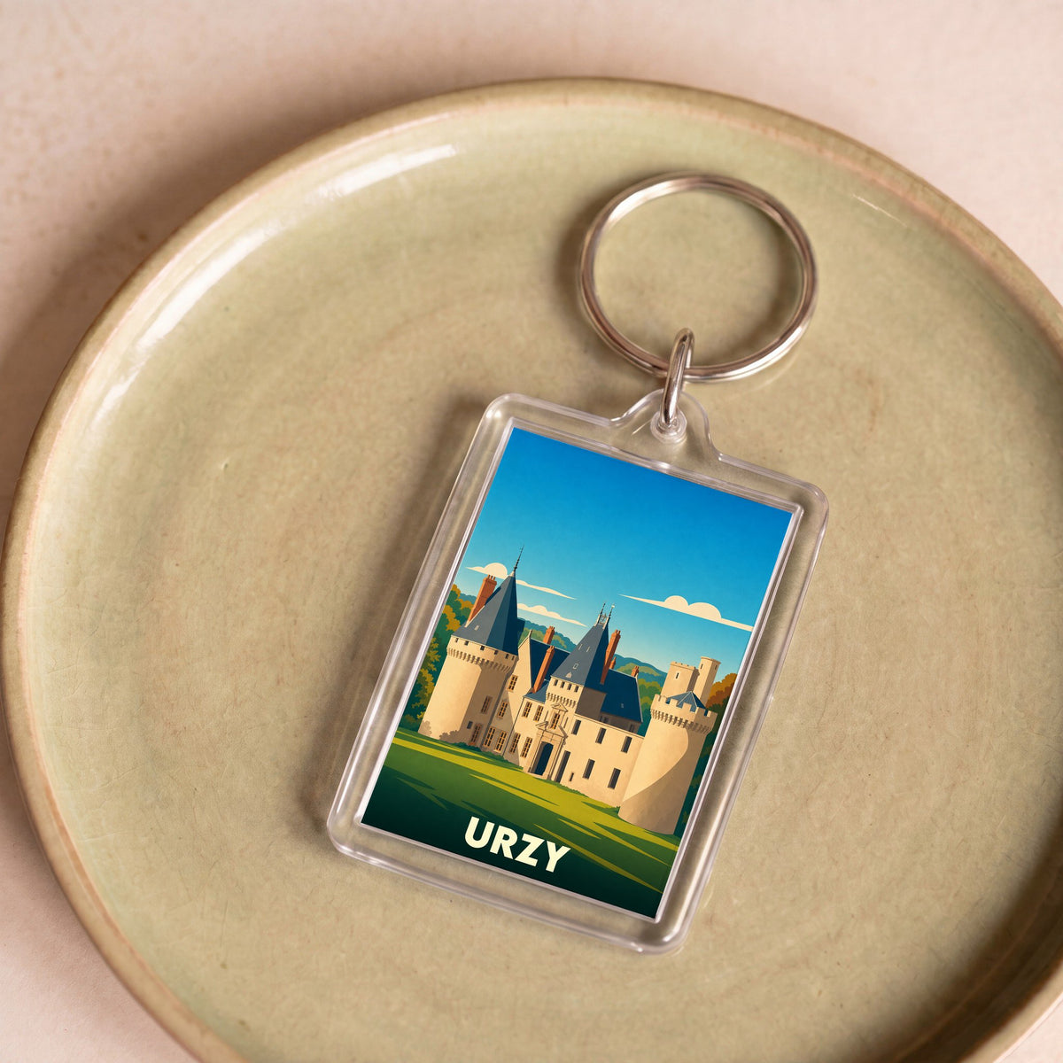 Porte-clés souvenir de la ville de Urzy avec une illustration stylisée d'un château.