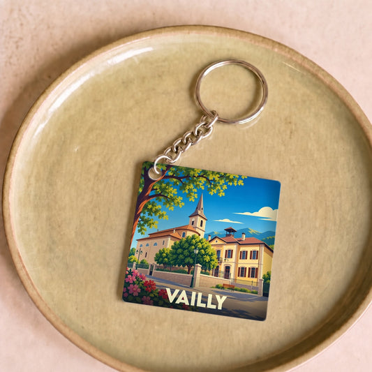 Porte-clés souvenir de la ville de Vailly avec une illustration stylisée de son église et de ses paysages.