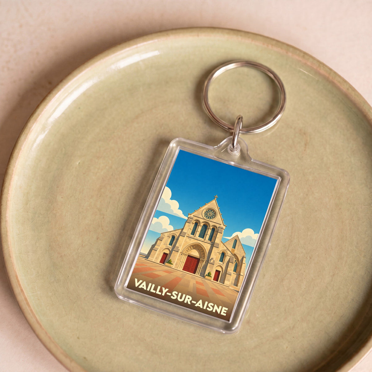 Porte-clés souvenir de la ville de Vailly-sur-Aisne avec une illustration stylisée de son église.