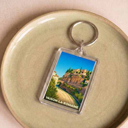Porte-clés souvenir de la ville de Vaison-la-Romaine avec une illustration stylisée.