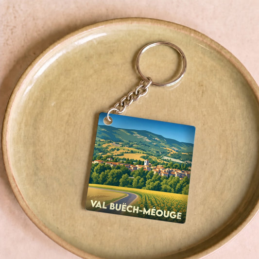 Porte-clés souvenir de Val Buëch-Méouge avec une illustration stylisée d'un paysage provençal.