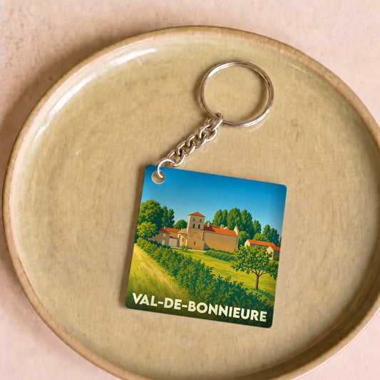 Porte-clés souvenir de Val-de-Bonnieure avec une illustration stylisée de la ville.