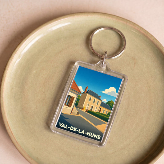 Porte-clés souvenir de Val-de-la-Hune avec une illustration stylisée d'un village français.
