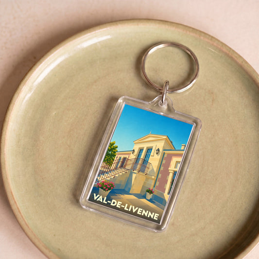 Porte-clés souvenir de la ville de Val-de-Livenne avec une illustration stylisée.