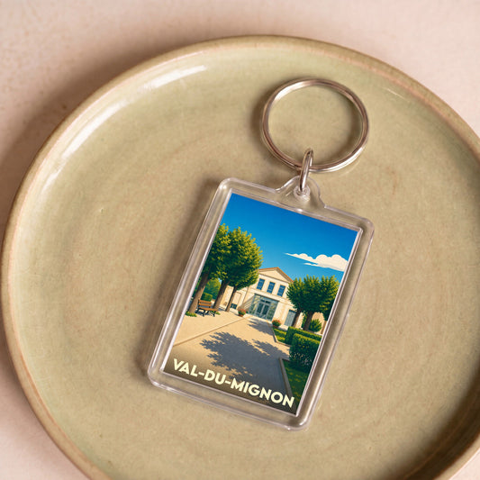 Porte-clés souvenir de la ville de Val-du-Mignon avec une illustration stylisée.
