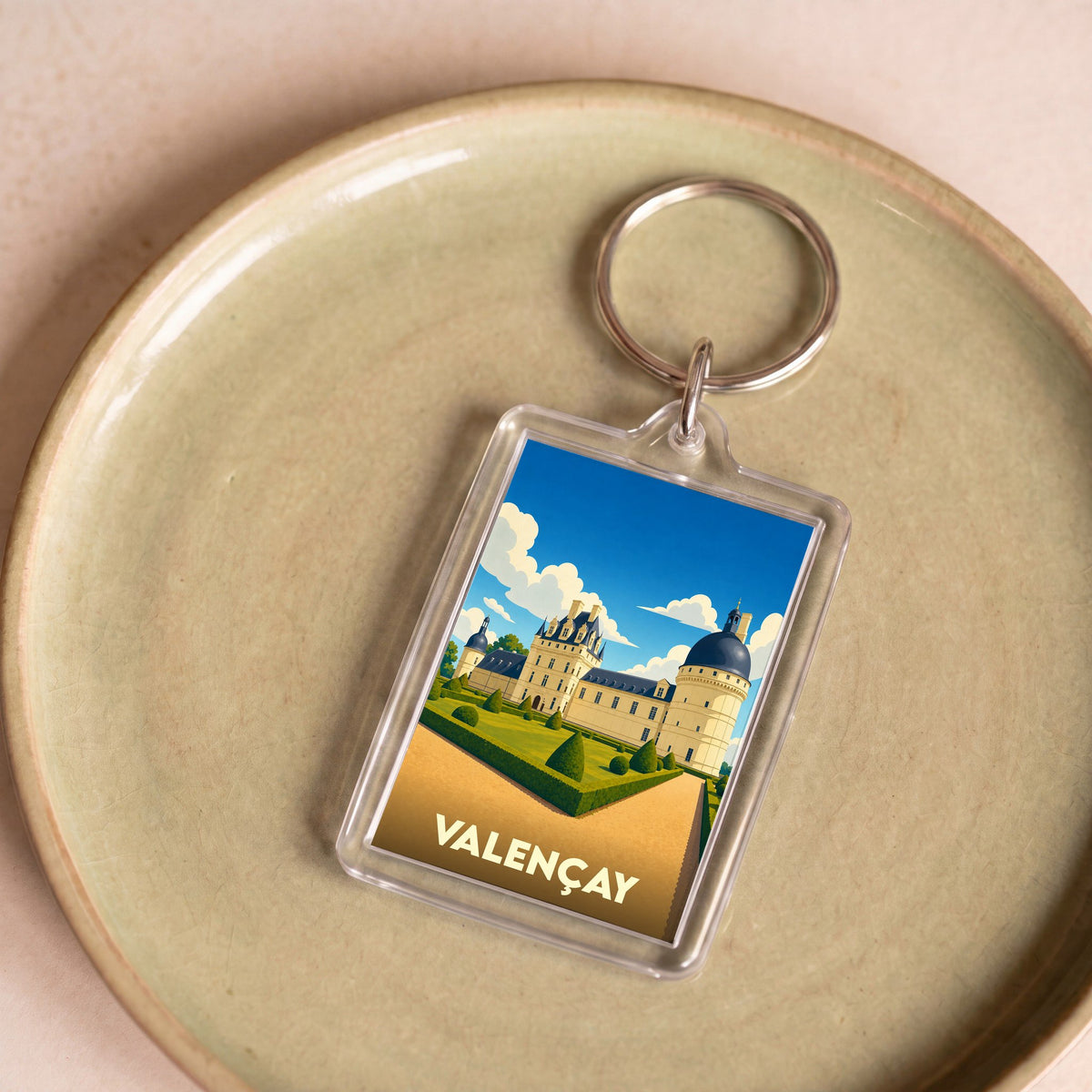 Porte-clés souvenir de la ville de Valençay avec une illustration stylisée de son château.