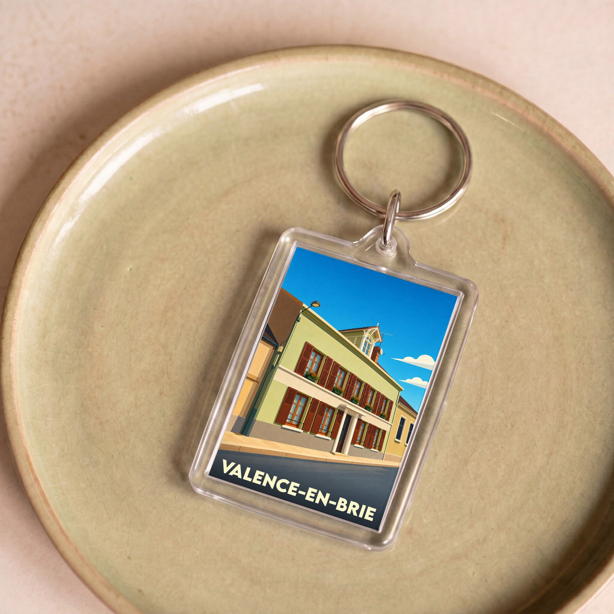 Porte-clés souvenir de Valence-en-Brie orné d'une illustration stylisée de la ville.