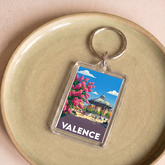 Porte-clés souvenir de la ville de Valence avec une illustration colorée et stylisée.