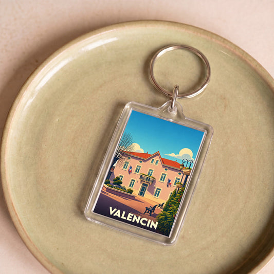Porte-clés souvenir de la ville de Valencin avec une illustration stylisée de sa mairie.