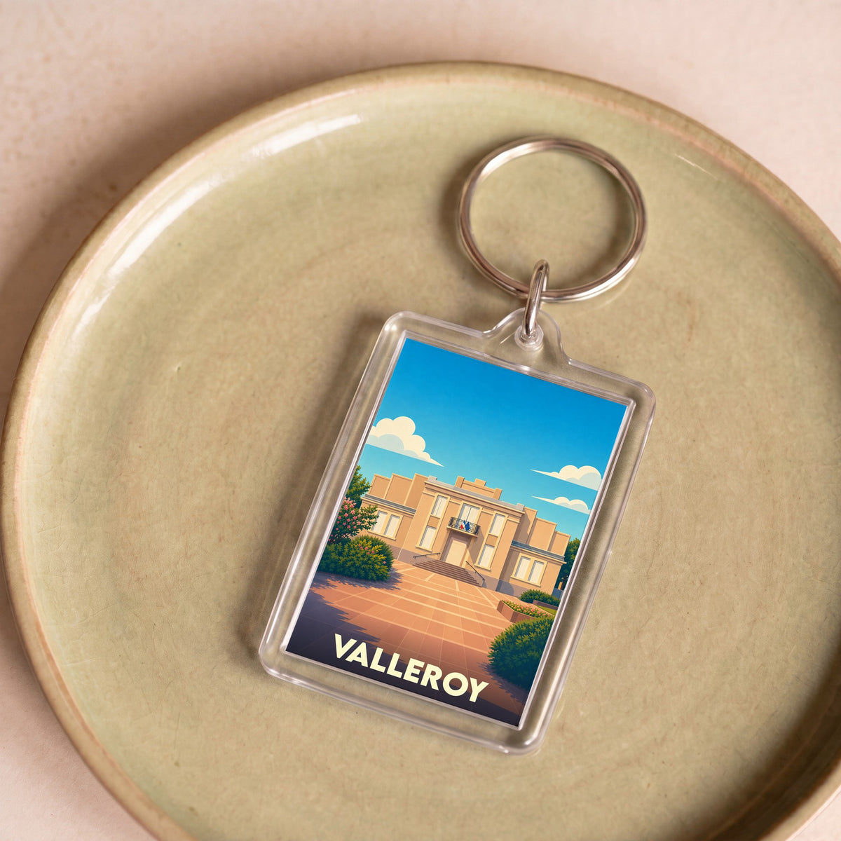 Porte-clés souvenir de la ville de Valleroy avec une illustration stylisée.