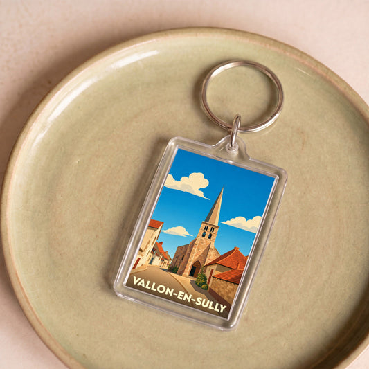 Porte-clés souvenir de la ville de Vallon-en-Sully avec une illustration stylisée de son église.