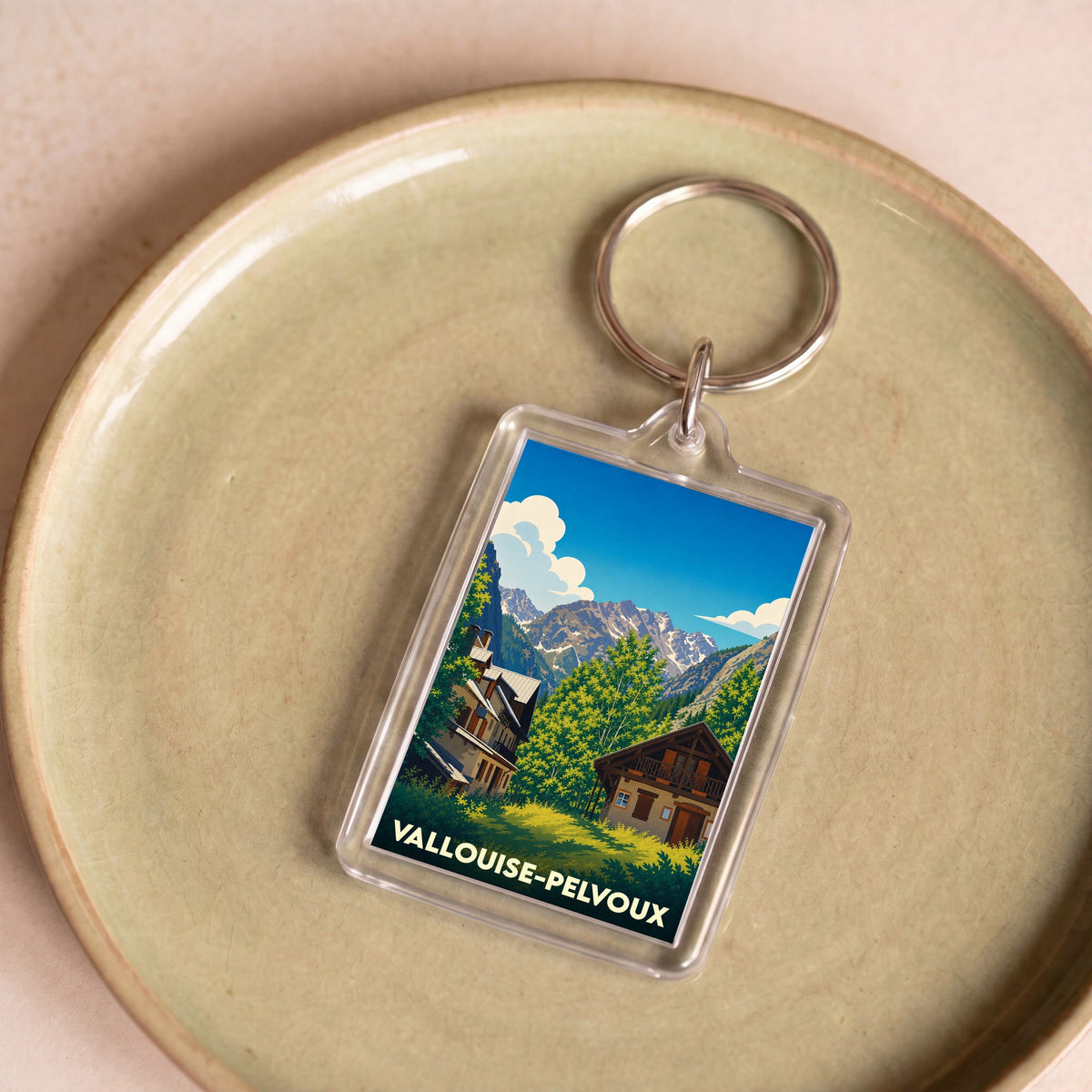 Porte-clés souvenir de la ville de Vallouise-Pelvoux avec une illustration de paysage de montagne.