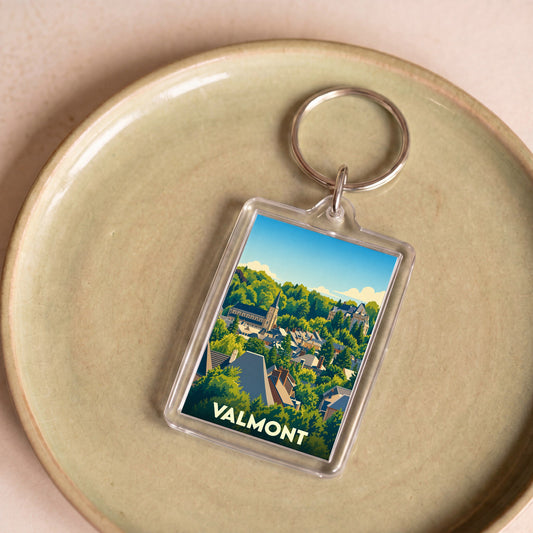 Porte-clés souvenir de la ville de Valmont avec une illustration stylisée.