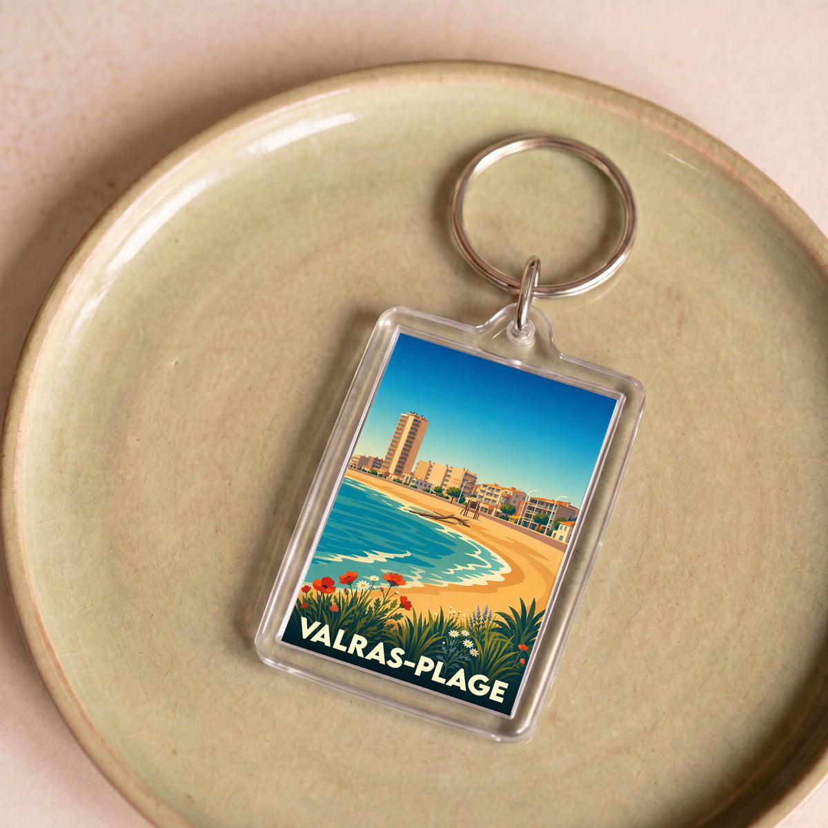 Porte-clés souvenir de Valras-Plage avec une illustration stylisée de son front de mer.