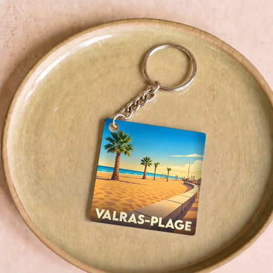 Porte-clés souvenir de Valras-Plage avec une illustration stylisée d'une plage bordée de palmiers.
