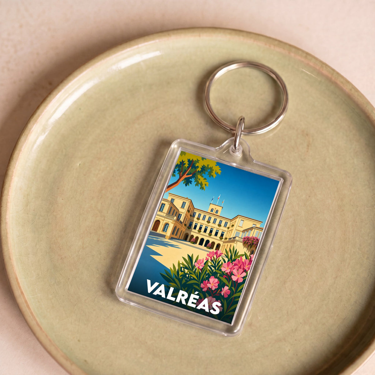 Porte-clés souvenir de la ville de Valréas avec une illustration colorée du château de Simiane.