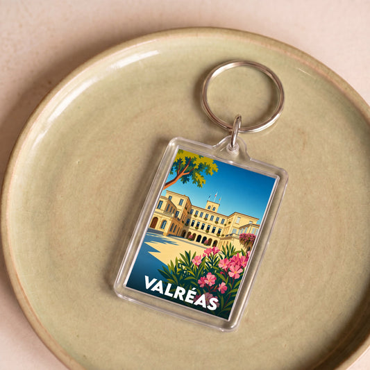 Porte-clés souvenir de la ville de Valréas avec une illustration colorée du château de Simiane.