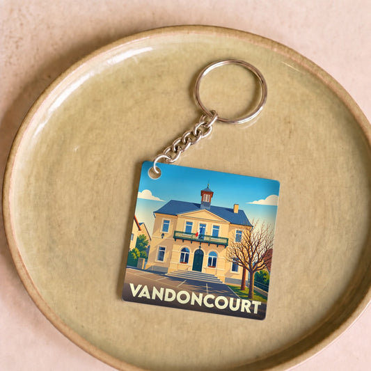 Porte-clés souvenir de la ville de Vandoncourt avec une illustration stylisée de sa mairie.