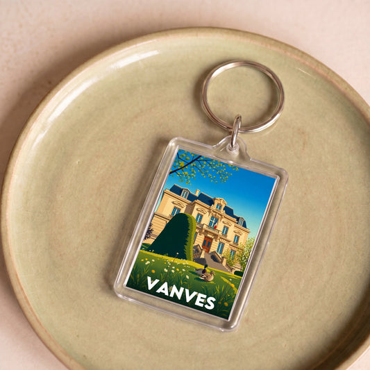 Porte-clés souvenir de la ville de Vanves avec une illustration stylisée d'un bâtiment historique.