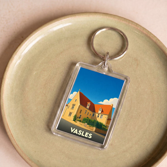 Porte-clés souvenir de la ville de Vasles avec une illustration stylisée.