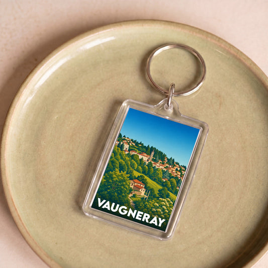 Porte-clés souvenir de la ville de Vaugneray avec une illustration stylisée.