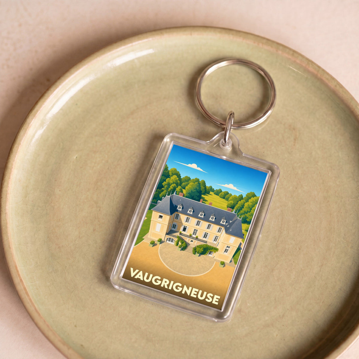 Porte-clés souvenir de la ville de Vaugrigneuse avec une illustration stylisée de son château.
