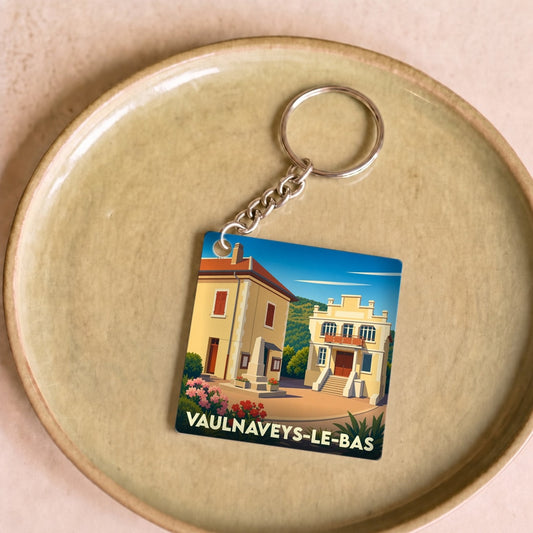 Porte-clés souvenir de la ville de Vaulnaveys-le-Bas avec une illustration stylisée.
