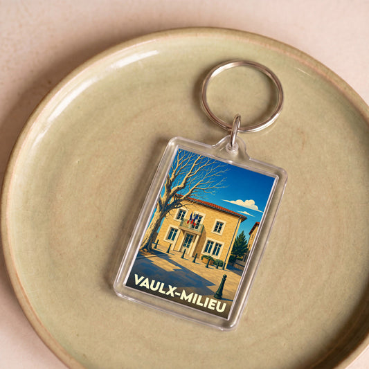 Porte-clés souvenir de la ville de Vaulx-Milieu avec une illustration stylisée de sa mairie.